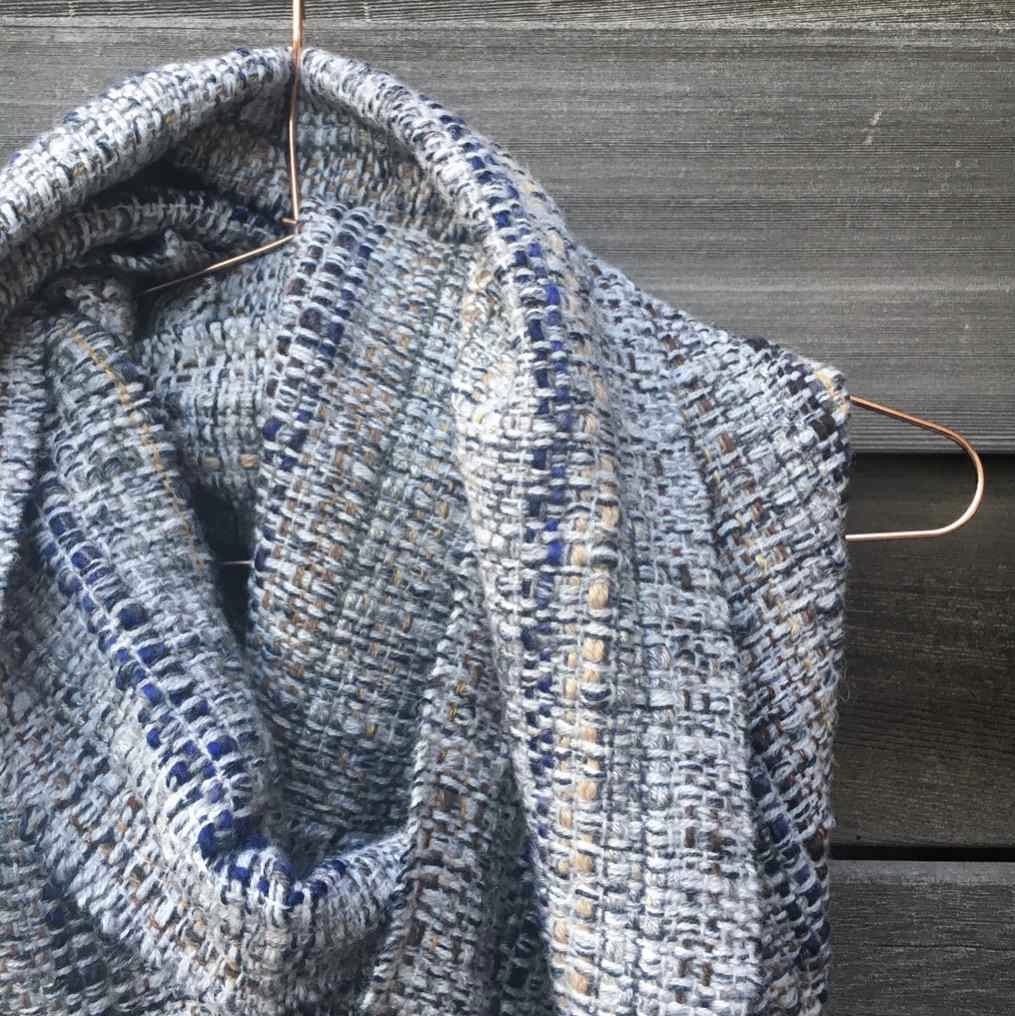 Handwoven scarf in blue and grey with detail of weave pattern