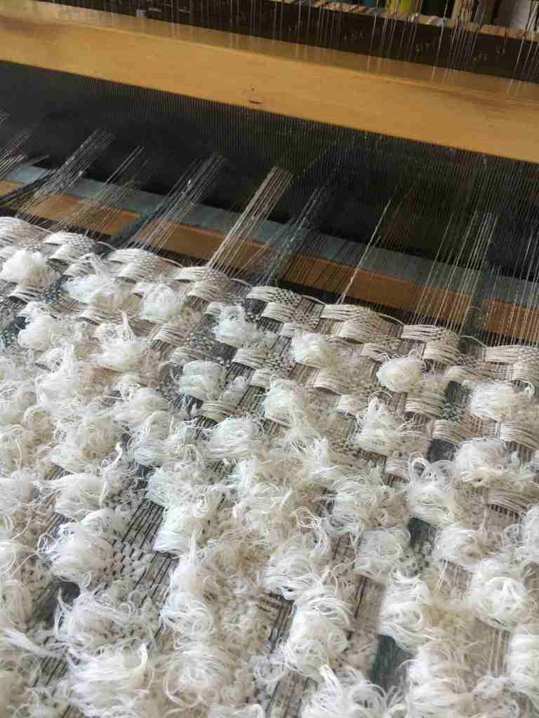 Fluffy weave on loom from side