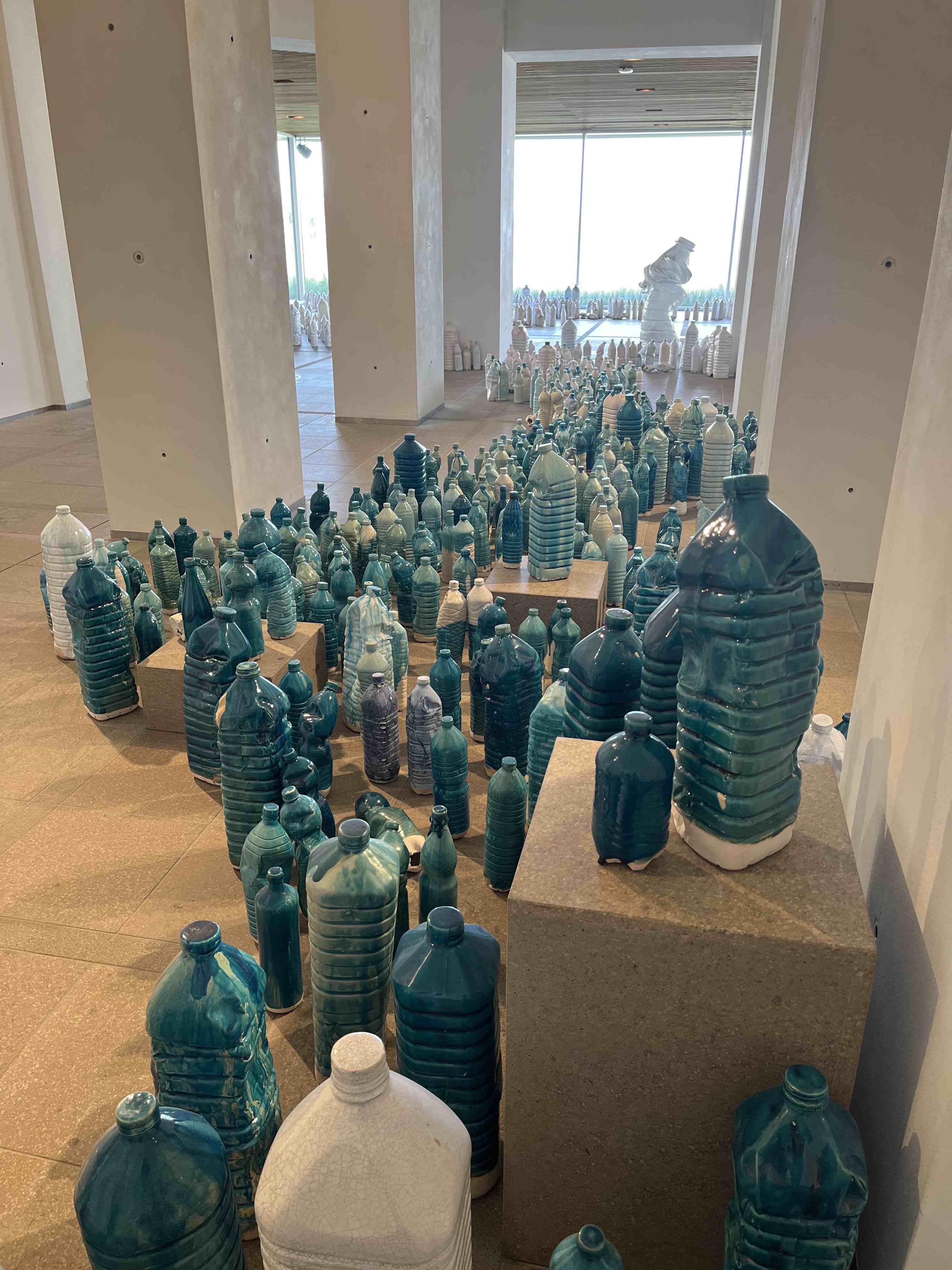 Ceramic bottles flowing through gallery at Beelden aan Zee