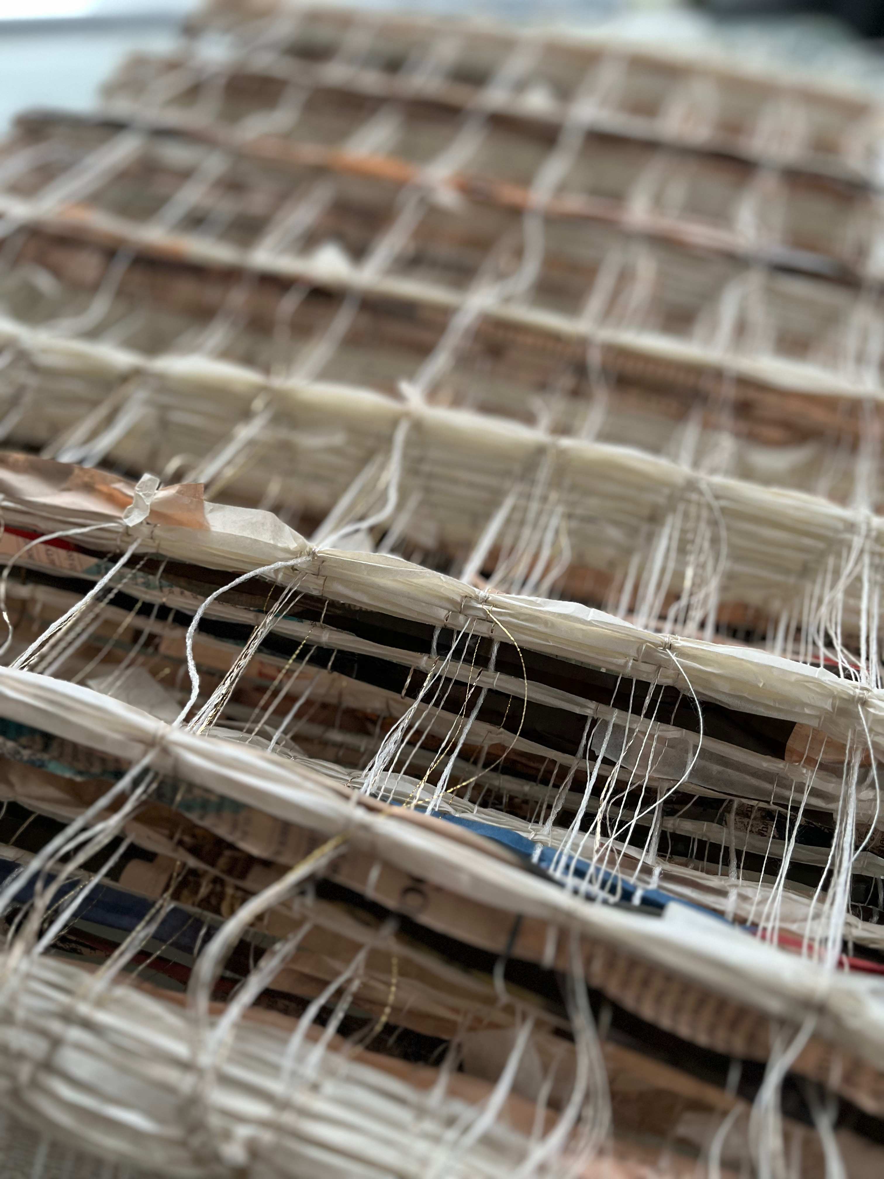 Detail of newspaper honeycomb weave with contrasting warp